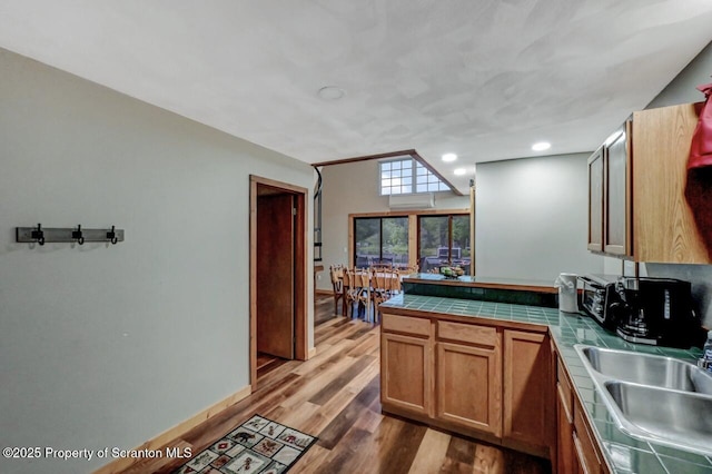 482 Lakeview Dr, Kingsley, PA 18826 - kitchen featuring tile countertops, a sink, a peninsula, light wood-style flooring, and brown cabinets