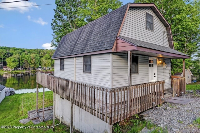 482 Lakeview Dr, Kingsley, PA 18826 - view of front of property featuring roof with shingles, a water view, a gambrel roof, a front yard, and covered porch