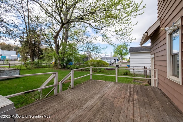 wooden terrace with a lawn and a fenced backyard