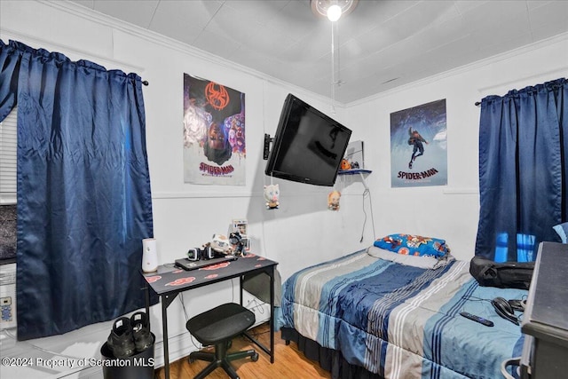 bedroom featuring wood-type flooring and crown molding