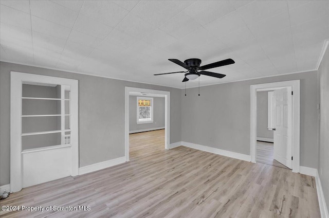 spare room with ceiling fan and light wood-type flooring