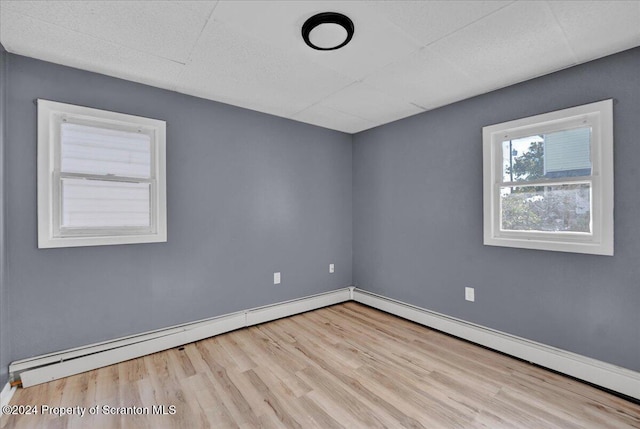 spare room featuring light hardwood / wood-style flooring and baseboard heating