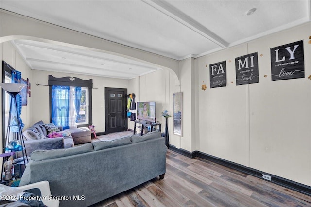 living room featuring beam ceiling and hardwood / wood-style flooring