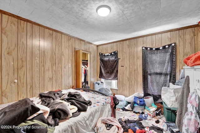 bedroom with wood walls and crown molding