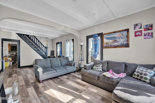 living room featuring beamed ceiling and hardwood / wood-style floors