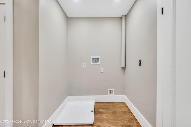 clothes washing area featuring hookup for an electric dryer, washer hookup, and hardwood / wood-style floors