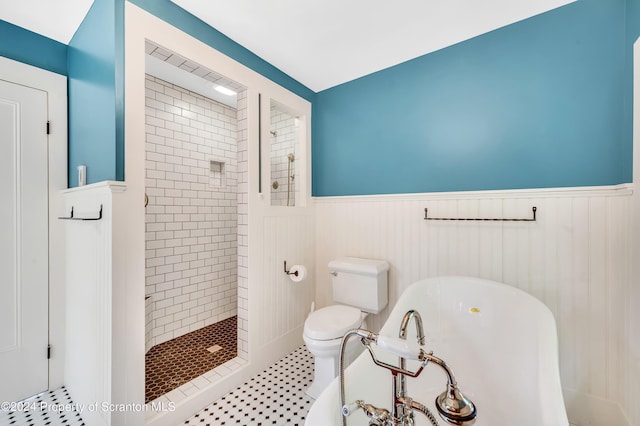 bathroom featuring toilet and a tile shower