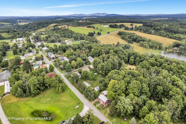 drone / aerial view featuring a water and mountain view