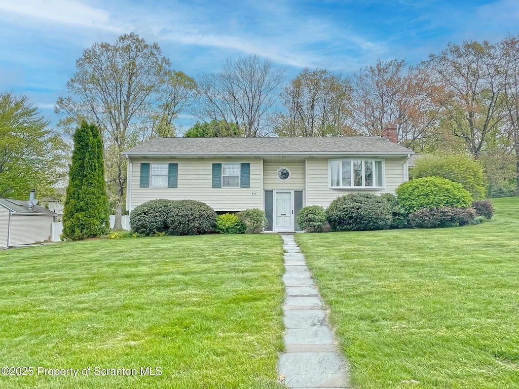 823 Hilltop Dr, Clarks Summit, PA 18411 - bi-level home featuring a chimney and a front lawn