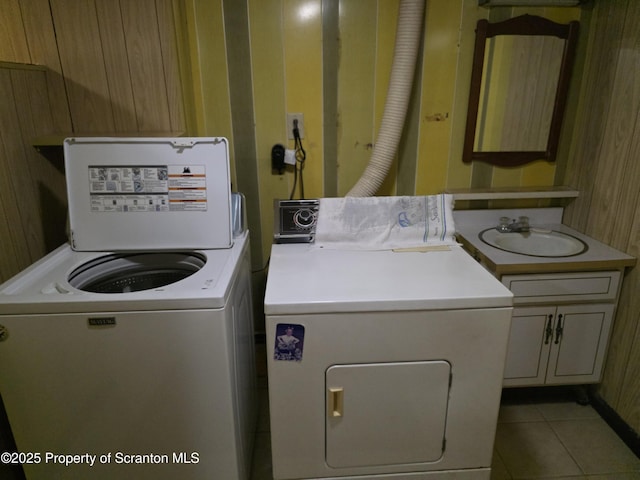 96 W Swallow St, Olyphant, PA 18447 - washroom with cabinet space, washing machine and clothes dryer, tile patterned floors, and wooden walls