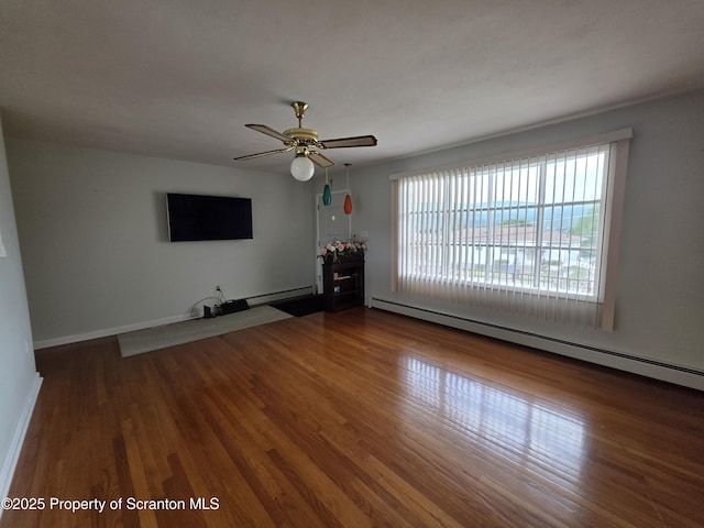 96 W Swallow St, Olyphant, PA 18447 - unfurnished living room with baseboard heating, wood finished floors, a ceiling fan, and a baseboard heating unit