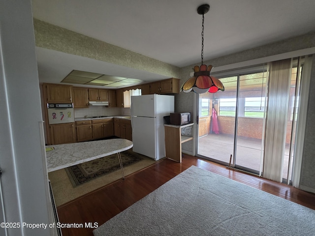 96 W Swallow St, Olyphant, PA 18447 - kitchen featuring freestanding refrigerator, dark wood-style floors, light countertops, and stovetop