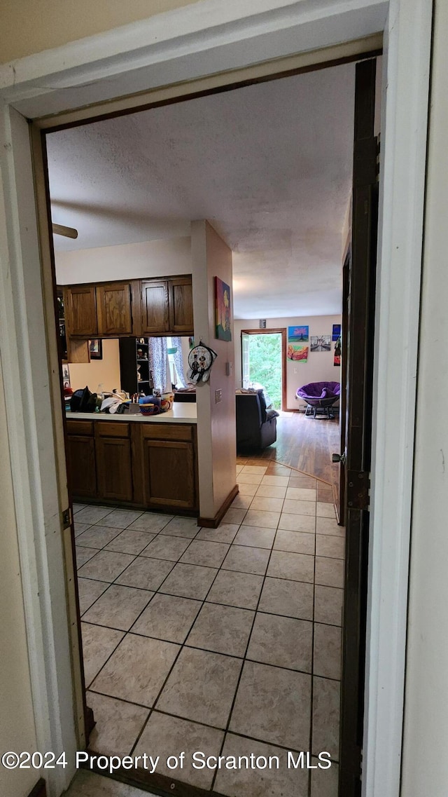 kitchen with light tile patterned floors and ceiling fan