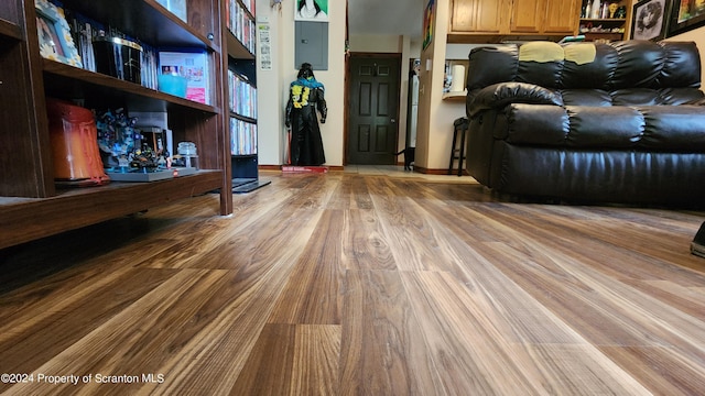 living room with electric panel and light hardwood / wood-style floors