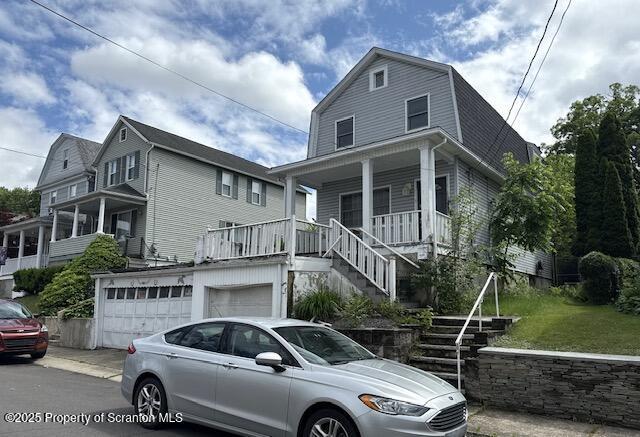 225 Taft St, Hanover Twp, PA 18706 - colonial inspired home featuring stairs, a gambrel roof, a porch, a garage, and driveway