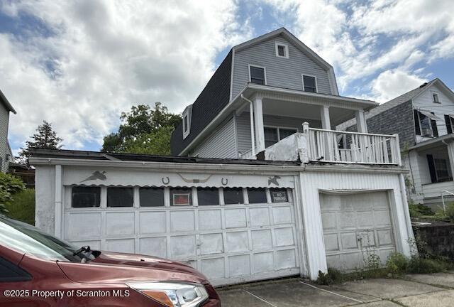 225 Taft St, Hanover Twp, PA 18706 - view of front of house featuring a balcony, a garage, and a gambrel roof