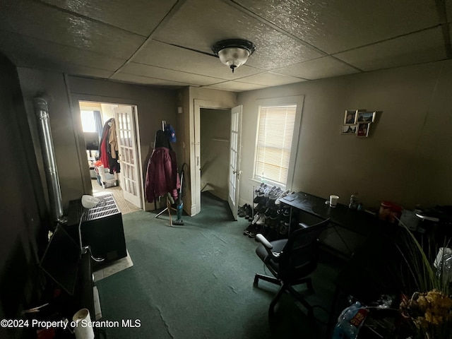 miscellaneous room with carpet flooring and a drop ceiling