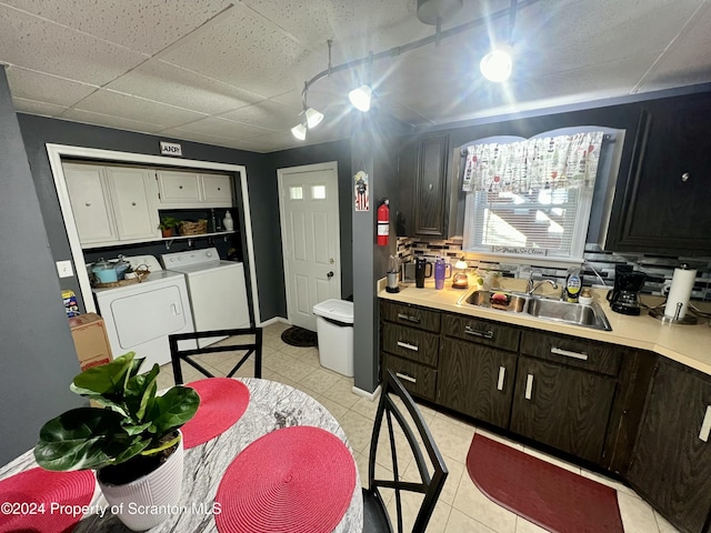 546 Emmett St, Scranton, PA 18505 - kitchen featuring washer and clothes dryer, light tile patterned floors, light countertops, dark brown cabinetry, and backsplash