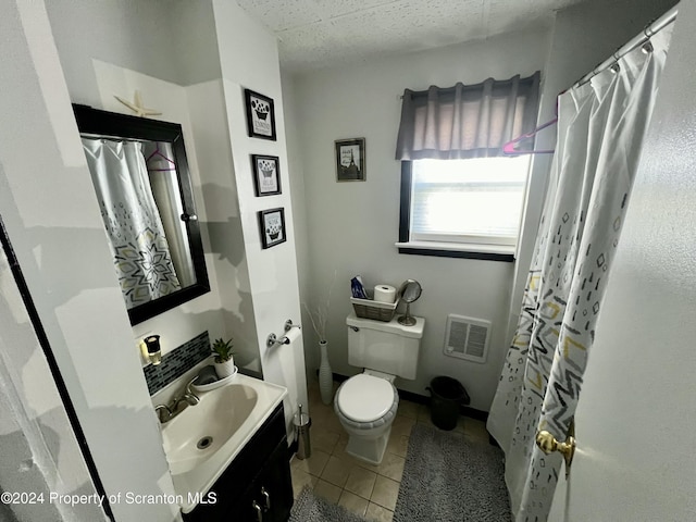 bathroom with a paneled ceiling, walk in shower, vanity, tile patterned flooring, and toilet