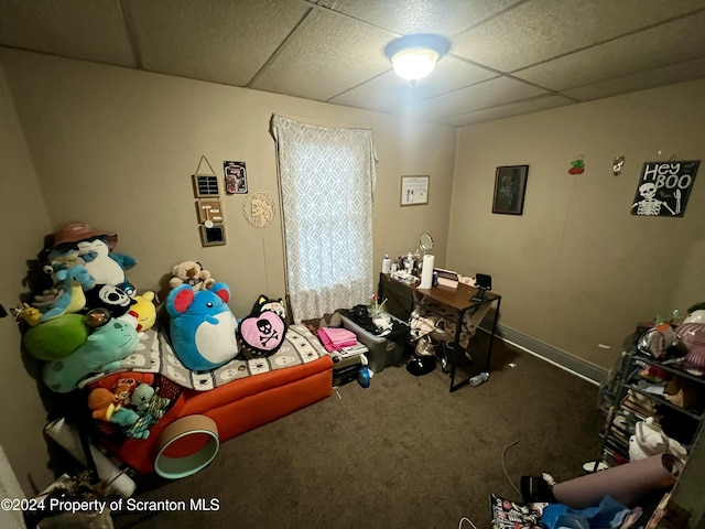 bedroom featuring carpet and a drop ceiling