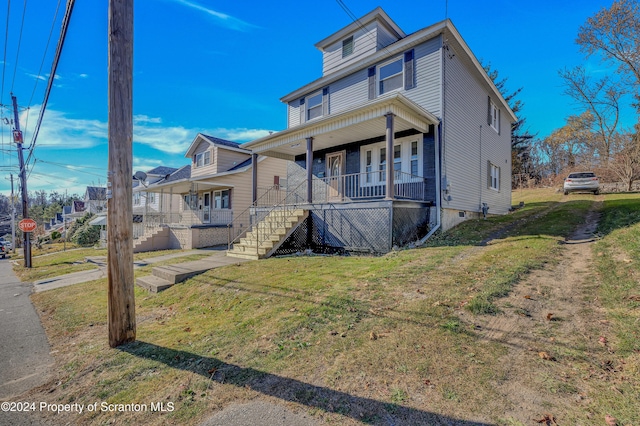 view of front of house with covered porch and a front yard