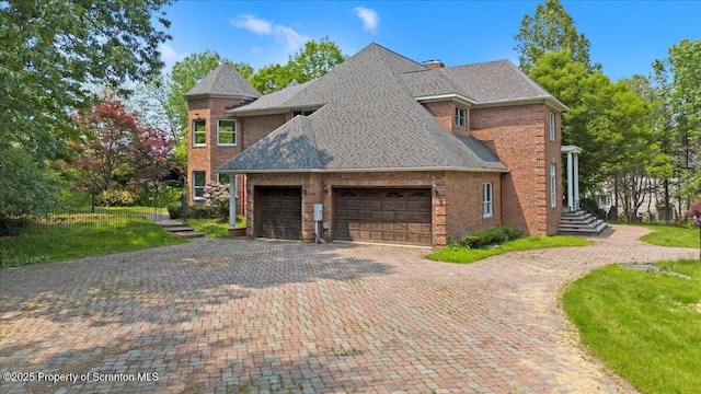 441 Hidden Lake Dr, East Stroudsburg, PA 18302 - view of property exterior with a garage, brick siding, driveway, a shingled roof, and a lawn