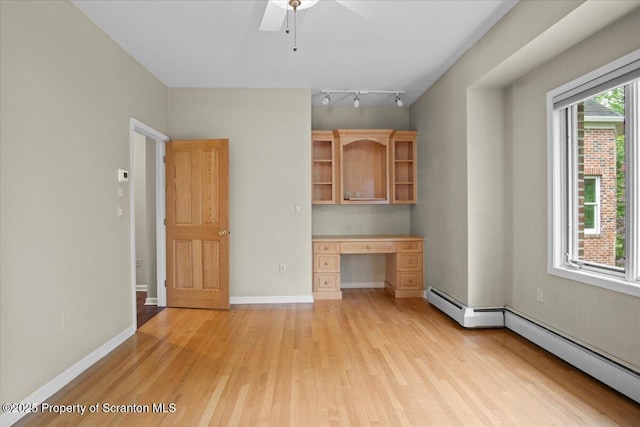 441 Hidden Lake Dr, East Stroudsburg, PA 18302 - unfurnished living room featuring built in desk, light wood-type flooring, a ceiling fan, and a baseboard radiator