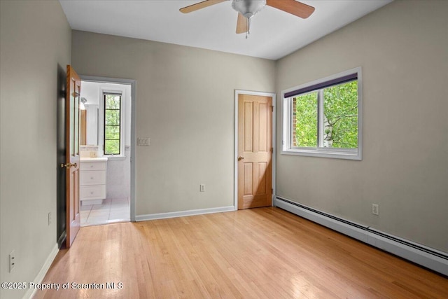 441 Hidden Lake Dr, East Stroudsburg, PA 18302 - unfurnished bedroom with baseboard heating, multiple windows, light wood-type flooring, and ensuite bathroom