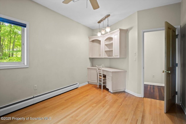 441 Hidden Lake Dr, East Stroudsburg, PA 18302 - unfurnished office with baseboard heating, a ceiling fan, light wood-style flooring, and built in desk