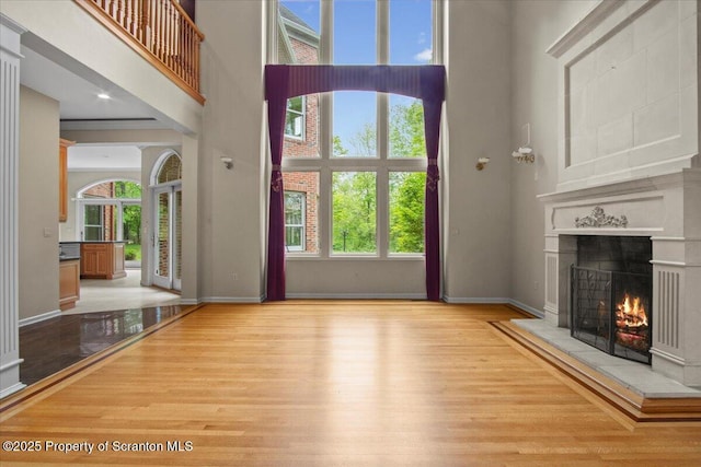 441 Hidden Lake Dr, East Stroudsburg, PA 18302 - unfurnished living room with a high ceiling, a tile fireplace, and wood finished floors