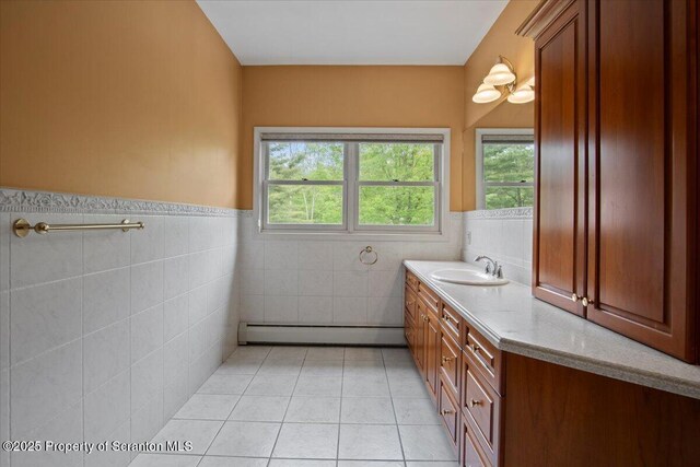 441 Hidden Lake Dr, East Stroudsburg, PA 18302 - bathroom with a baseboard radiator, vanity, tile walls, tile patterned flooring, and a wainscoted wall