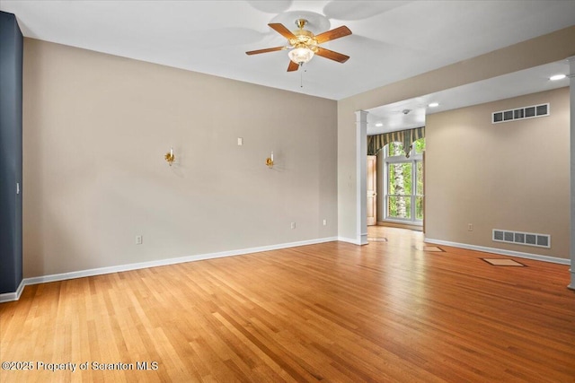 441 Hidden Lake Dr, East Stroudsburg, PA 18302 - empty room with light wood finished floors, ceiling fan, and decorative columns