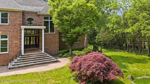 441 Hidden Lake Dr, East Stroudsburg, PA 18302 - view of exterior entry featuring brick siding, a shingled roof, and french doors