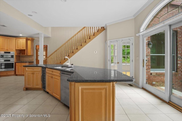 441 Hidden Lake Dr, East Stroudsburg, PA 18302 - kitchen featuring appliances with stainless steel finishes, light tile patterned floors, a center island with sink, dark stone countertops, and crown molding