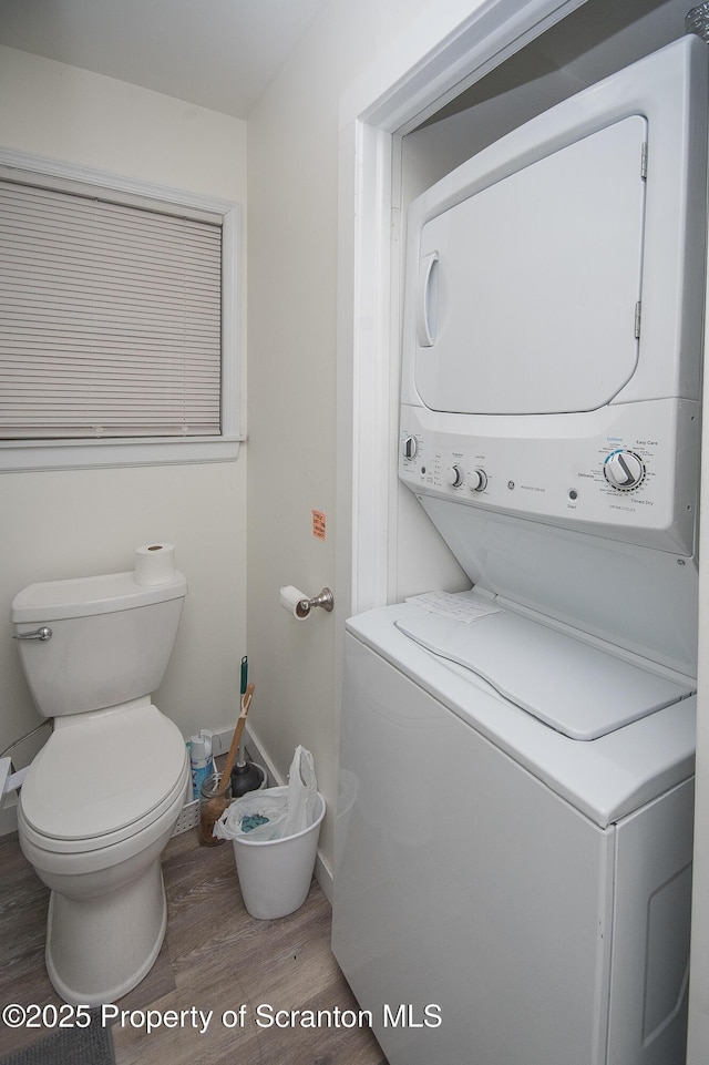 interior space featuring stacked washer / drying machine and wood-type flooring