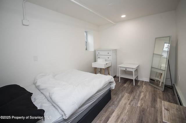 bedroom featuring dark wood-type flooring and a baseboard radiator