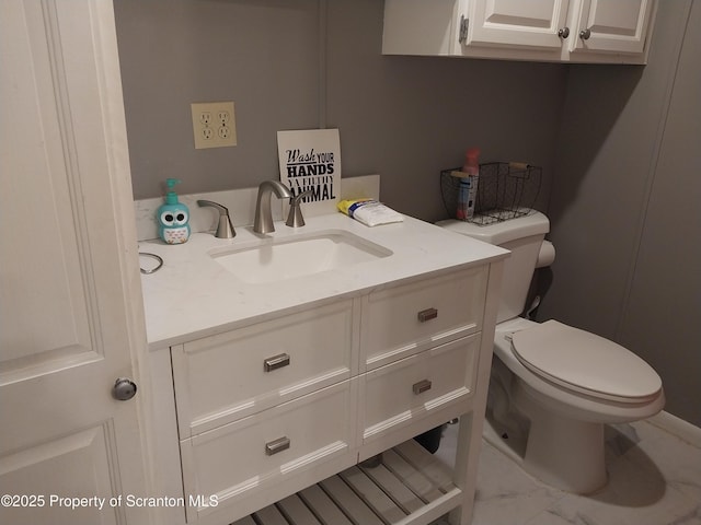 bathroom with toilet and vanity