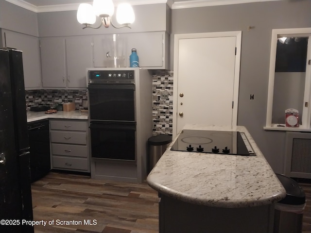 kitchen with backsplash, black appliances, and crown molding