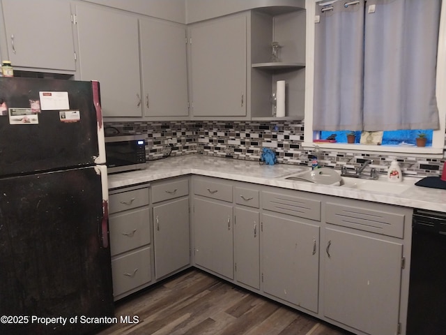 kitchen with tasteful backsplash, open shelves, gray cabinets, black appliances, and a sink