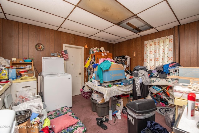 1010 Wood St, Old Forge, PA 18518 - miscellaneous room featuring wooden walls, carpet floors, a paneled ceiling, and stacked washer / dryer