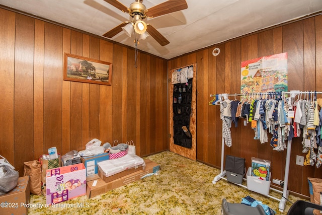 1010 Wood St, Old Forge, PA 18518 - carpeted bedroom featuring wood walls and a ceiling fan