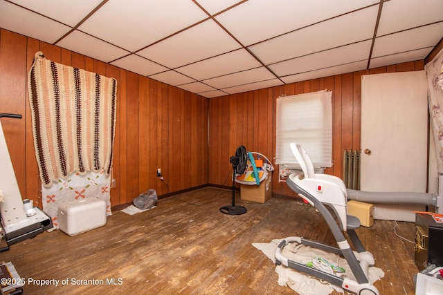 1010 Wood St, Old Forge, PA 18518 - workout area featuring a paneled ceiling, wood-type flooring, and wooden walls