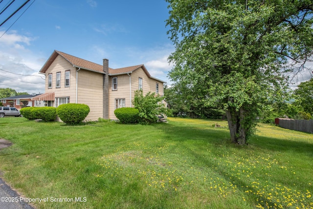 1010 Wood St, Old Forge, PA 18518 - view of home's exterior with a chimney and a lawn