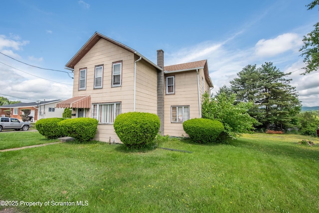 1010 Wood St, Old Forge, PA 18518 - view of home's exterior with a chimney and a lawn