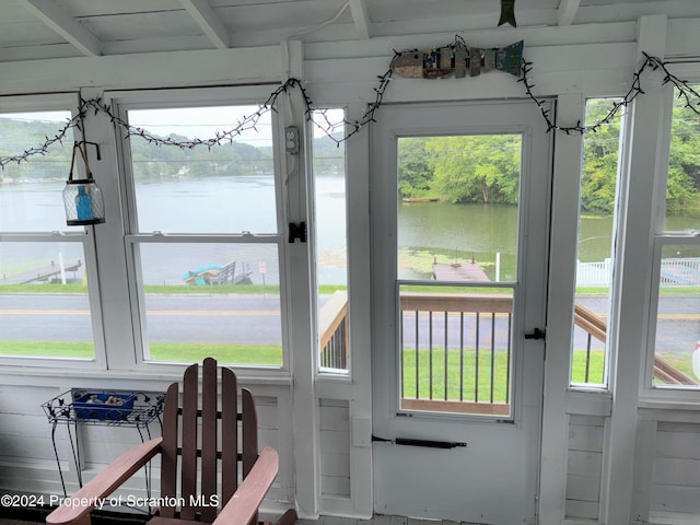 doorway with a healthy amount of sunlight and a water view