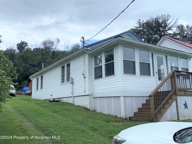 view of side of property with a yard