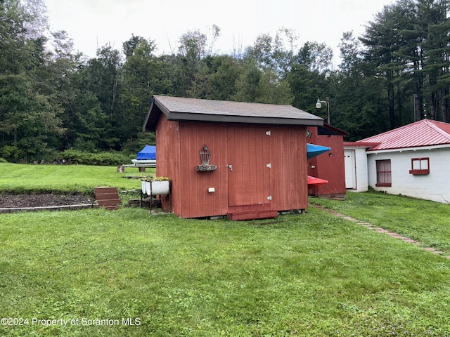 view of outdoor structure with a lawn