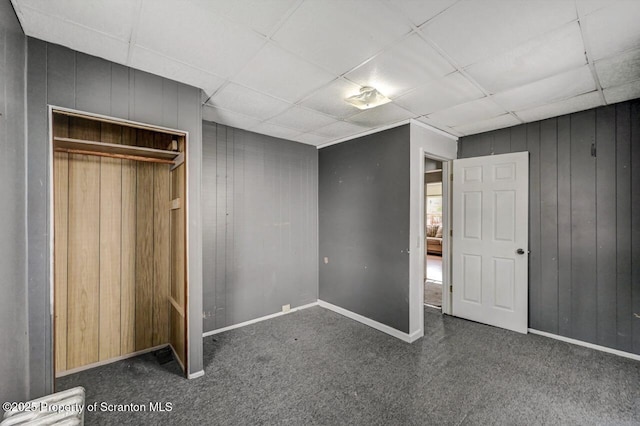 126-128 S Rebecca Ave S, Scranton, PA 18504 - unfurnished bedroom featuring carpet, baseboards, wooden walls, a closet, and a paneled ceiling