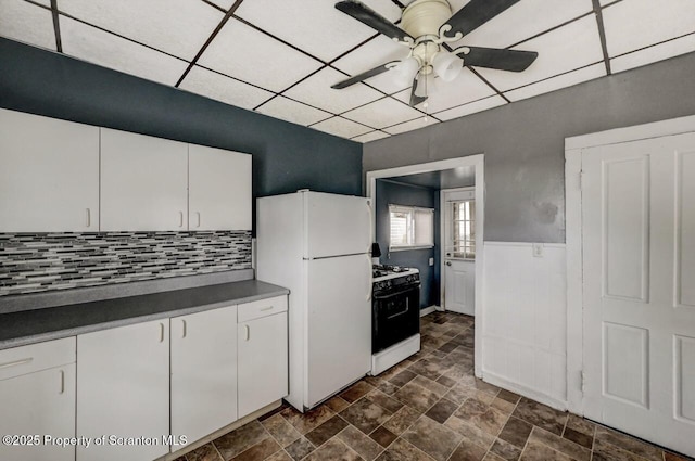 126-128 S Rebecca Ave S, Scranton, PA 18504 - kitchen with range with gas cooktop, freestanding refrigerator, ceiling fan, dark countertops, and white cabinets