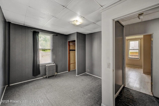 126-128 S Rebecca Ave S, Scranton, PA 18504 - unfurnished bedroom with radiator heating unit, carpet, and a drop ceiling